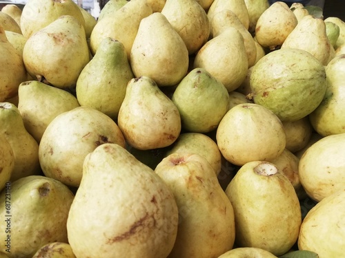 Close-up photo of guavas in fruit shop. Fruits background. Texture green guava.