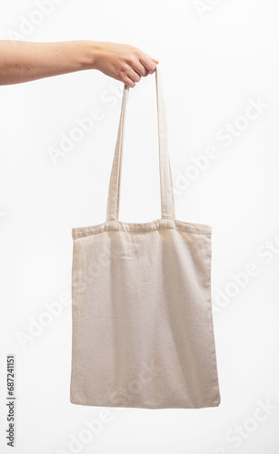 Natural cotton tote bag mockup in hand. Organic textile shopper, totebag