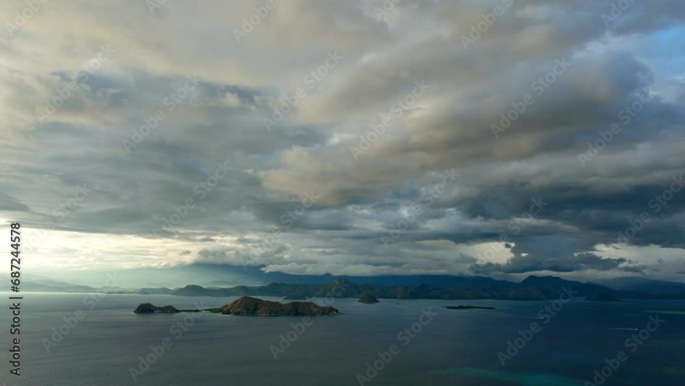 Aerial Time Lapse Tranquil View Of Famous Komodo Island, Drone Flying Forward Over Sea Under Fluffy Clouds Aerial Time Lapse Tranquil View Of Famous Komodo Island, Drone Flying Forward Over Sea Under Fluffy Clouds