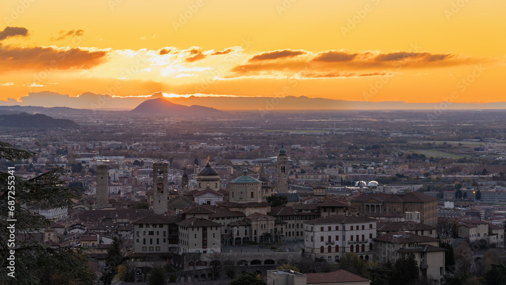 Bergamo, Italy. One of the beautiful city in Italy. Morning landscape at the old town from Saint Vigilio hill during fall season. Orange and red contest