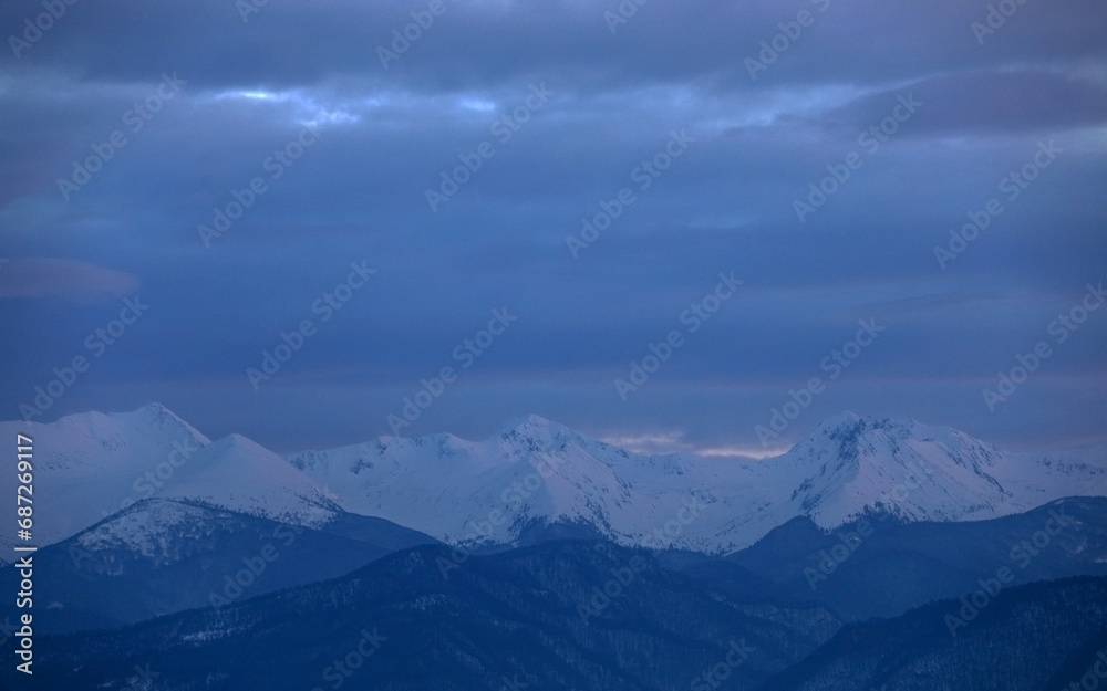 Winter alpine landscape in National Park Retezat, Carpathians, Romania, Europe. Snow covered moutains scenery