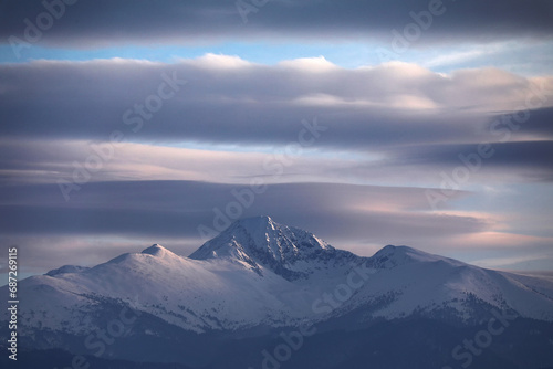 Winter alpine landscape in National Park Retezat, Carpathians, Romania, Europe. Snow covered moutains scenery 