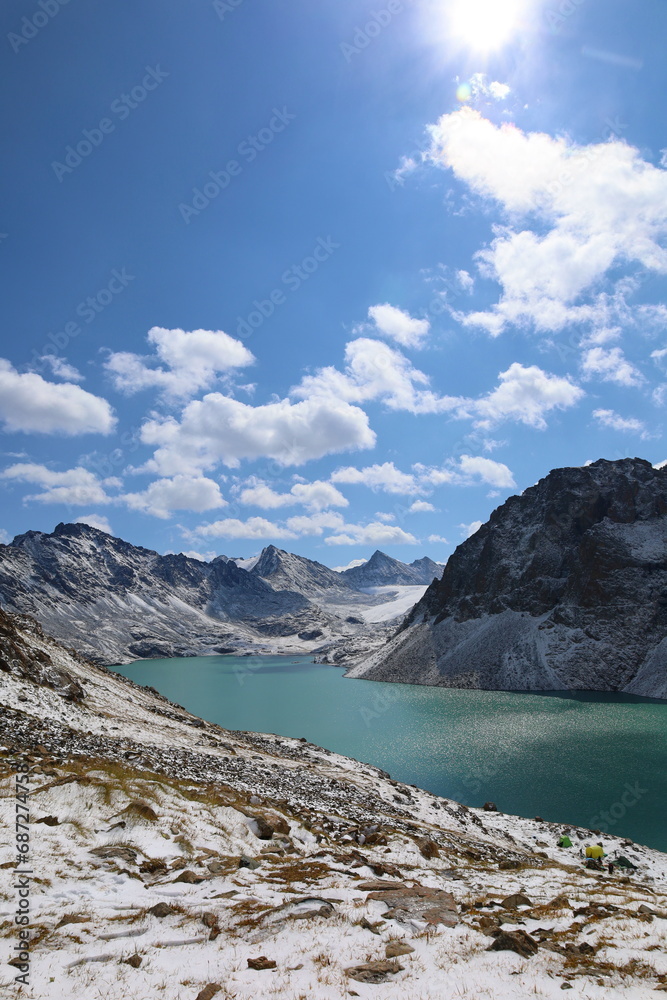 Obraz premium Ala-köl mountain lake with fresh snow during summer in Tian Shan mountains, Karakol, Kyrgyzstan