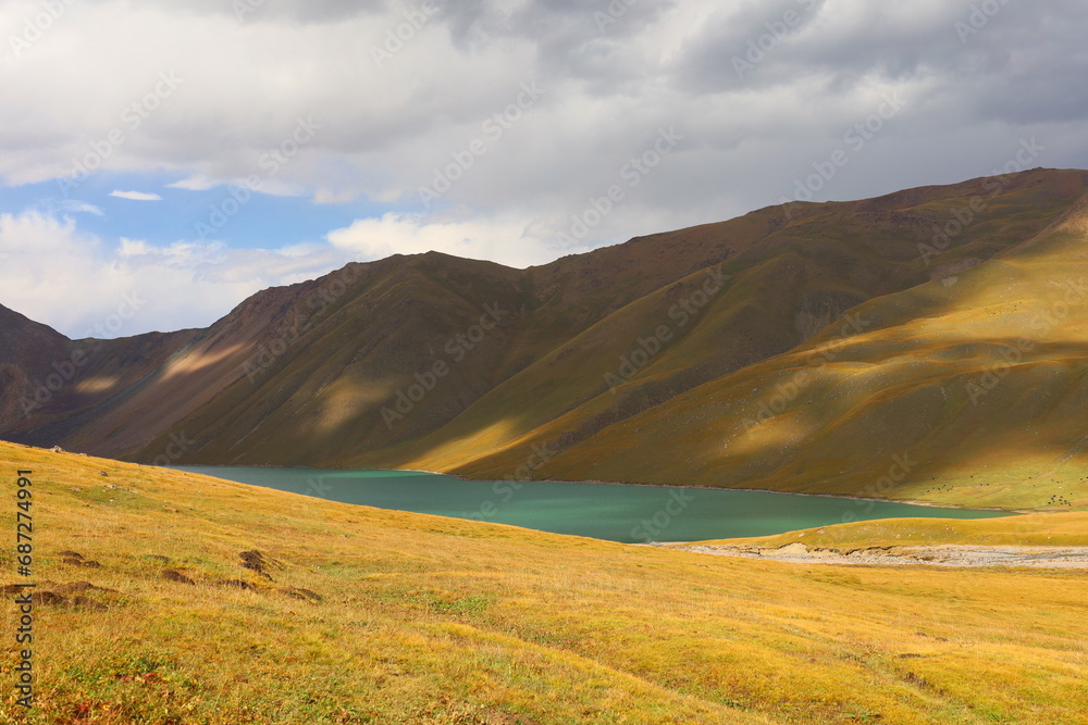 Kol Ukok lake surrounded by Tian Shan Mountains in Kochkor, Naryn region, Kyrgyzstan