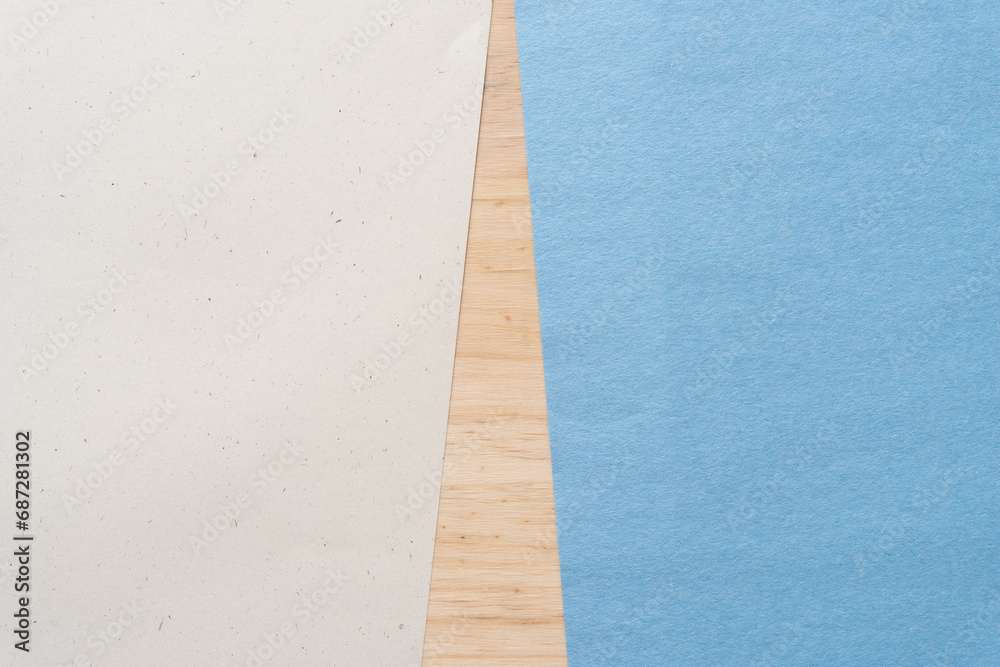 Fototapeta premium beige and blue construction paper sheets on wood (wedge shape)