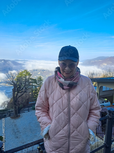 Portrait of a mature woman on the viewpoint in Brunate above Lake Como