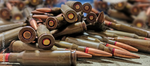 Cartridges for Kalashnikov assault rifle. War Concept. Heap of billets photo