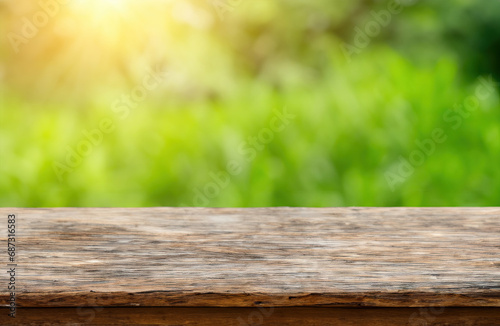 Old wooden table and blurred summer nature background