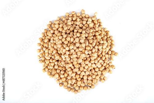 Pile of roasted nuts on white background. Hazelnuts harvest. Filbert photo wallpaper. Full frame of hazel. Peeled brown nut kernels. Healthy organic bio products. Vegetarian, vegan and raw food.