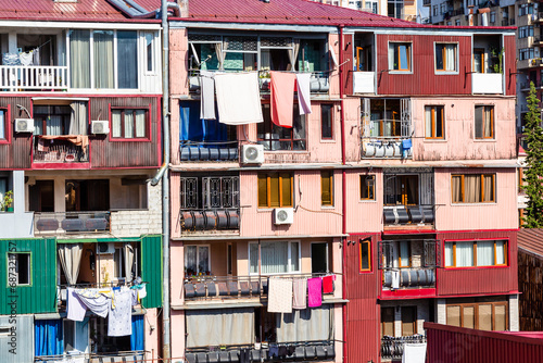 travel to Georgia - apartment building in residential district in Batumi city with laundry drying on balcony on sunny autumn day
