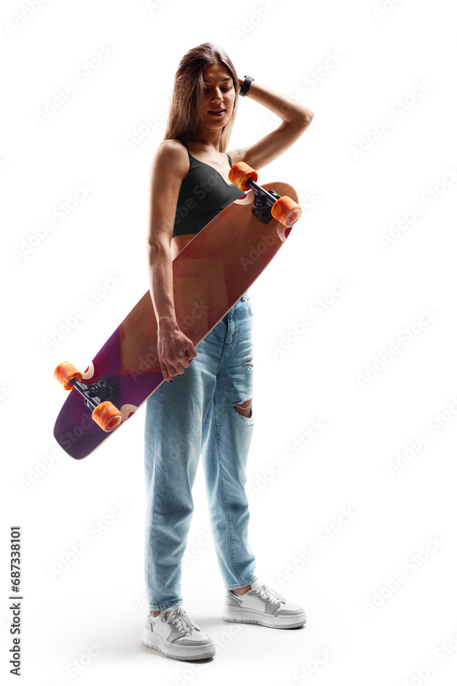 Girl with a skateboard. Beautiful and fashion young woman posing with a skateboard. Young longboard girl. Sport emotion. Sport. Isolated Girl with a skateboard. Beautiful and fashion young woman posing with a skateboard. Young longboard girl. Sport emotion. Sport. Isolated