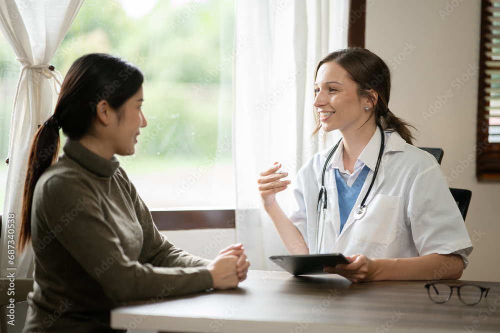 Female doctor sitting at work looking at the history of patients in the clinic or in the hospital Female doctor sitting at work looking at the history of patients in the clinic or in the hospital