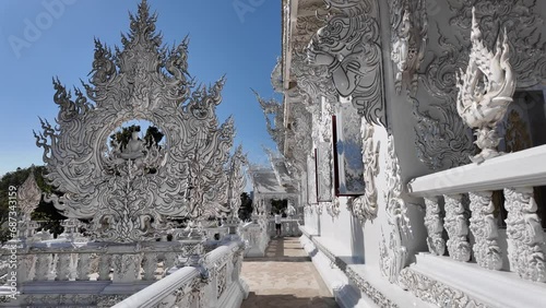 Chiang Rai, Thailand - November 27, 2023: White Temple or Wat Rong Khun is one of the landmark of Chiang Rai Province. It was created by Mr.Chalermchai Kositpipat, the famous Thai artist. photo