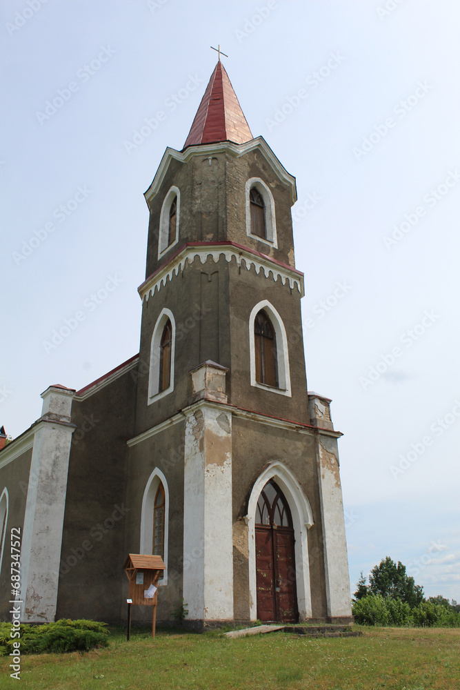 Steeple and front door of a Lutheran church in Sece, Latvia