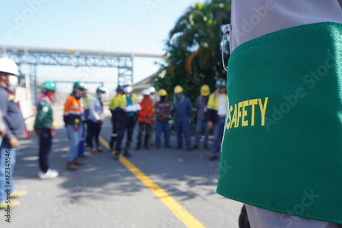 Green armband shows safety message in construction projects in industrial plant photo