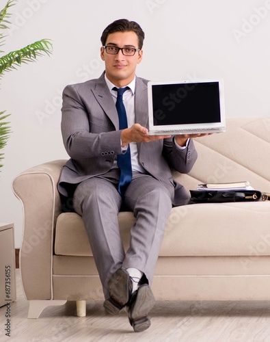 Businessman with laptop notebook sitting in sofa