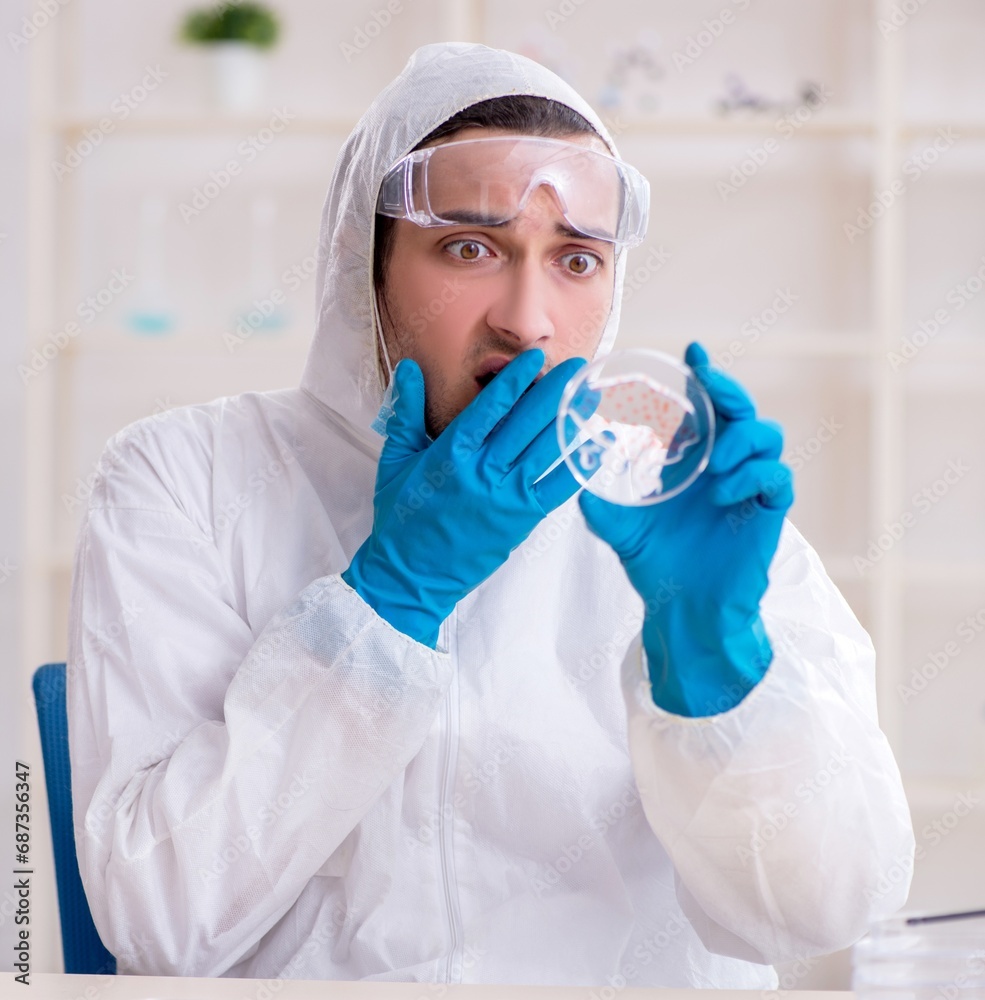 Young male chemist working in the lab Young male chemist working in the lab