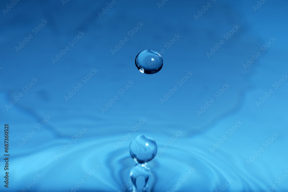 Splash of blue water with drop, macro view Splash of blue water with drop, macro view