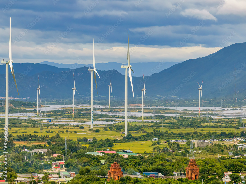 Naklejka premium Wind Turbines And Solar Panels At Sunset - Renewable Energy Concept. Ninh Thuan, Vietnam