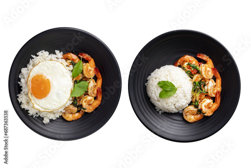 Stir-fried shrimp with basil, Thai street food, arranged on a black plate with a fried egg. Spicy Thai food separated from the background, top view - clipping path