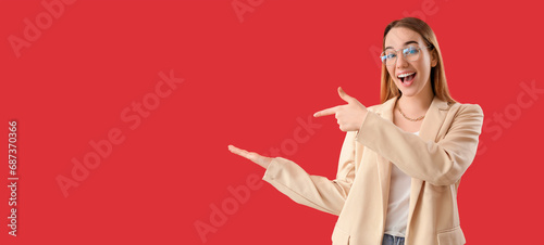 Happy businesswoman pointin...