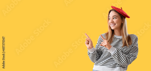 Young woman pointing at som...