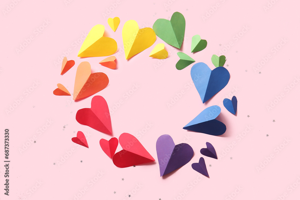Frame made of colorful paper hearts on pink background. LGBT concept Frame made of colorful paper hearts on pink background. LGBT concept