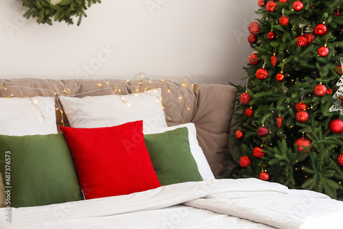 Big bed with Christmas lights in bedroom