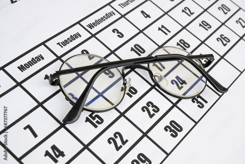 Eyeglasses on calendar page close up. Eyeglasses on calendar page close up.