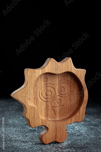 The children's plate in the shape of a cartoon character is made of wood for serving snacks, fruits, nuts, cheeses, meat and original serving of main dishes. Accessories for a modern kitchen.
