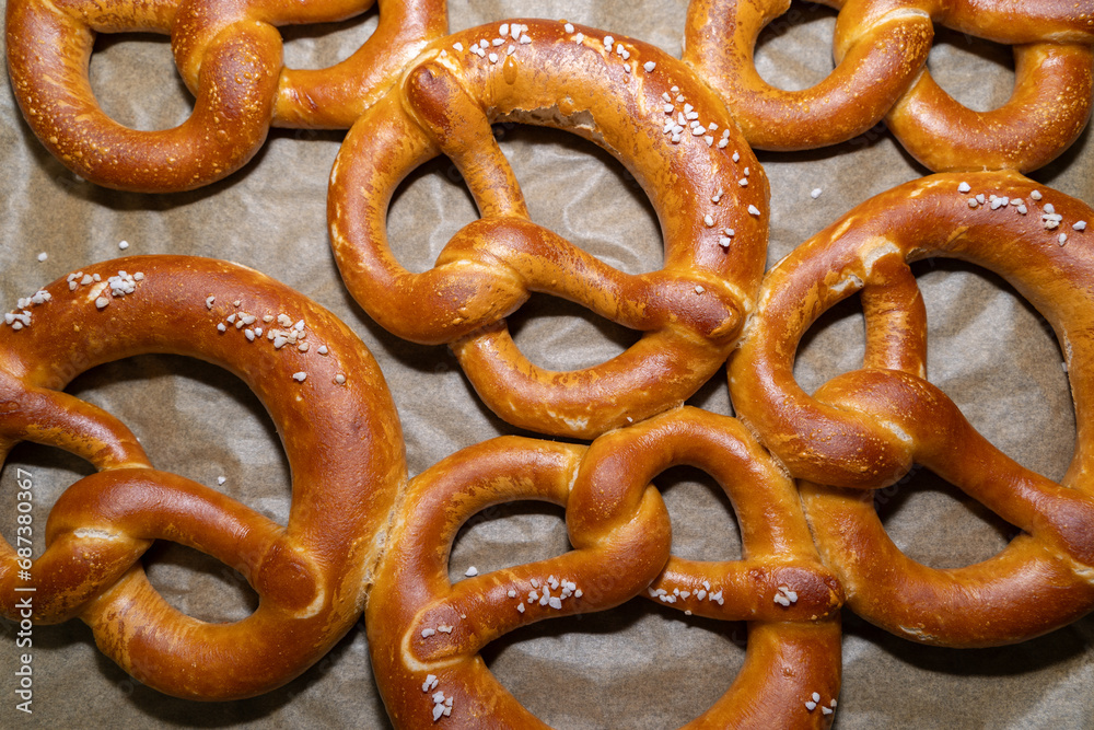 Baked pretzel with salt on the baking tray Baked pretzel with salt on the baking tray