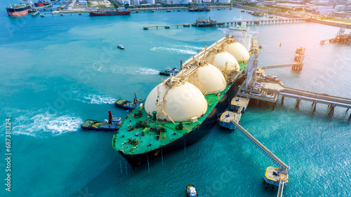 LNG (Liquefied natural gas) tanker anchored in Gas terminal gas tanks for storage. Oil Crude Gas Tanker Ship. LPG at Tanker Bay Petroleum Chemical or Methane freighter export import transportation.