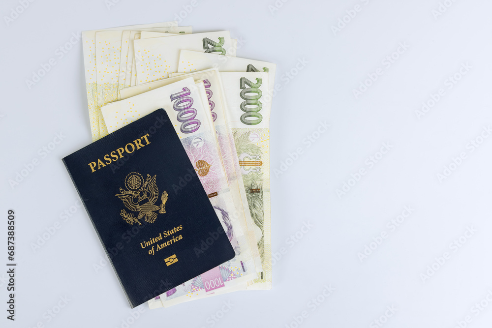 Czech currency koruna money bills and U.S. Passport with white background. Czech currency koruna money bills and U.S. Passport with white background.