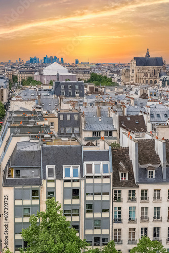 Paris, typical buildings in the Marais, aerial view with the Saint-Eustache church, and the Defense in background 
