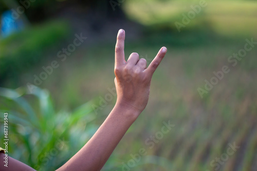 A man pointing two fingers of his hand forward and blur background © Rokonuzzamnan
