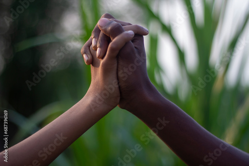 A man holding his hands together and blur background