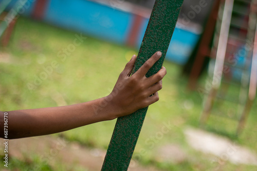 A man holding is iron pipe his hand blur background