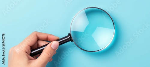 A hand holding magnifying glass on blue background. Generative AI technology.