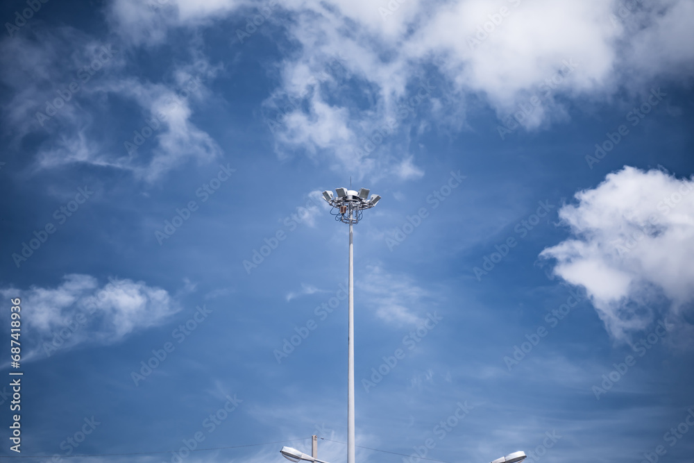 Electrical poles, spotlight poles on the background of the blue sky Electrical poles, spotlight poles on the background of the blue sky