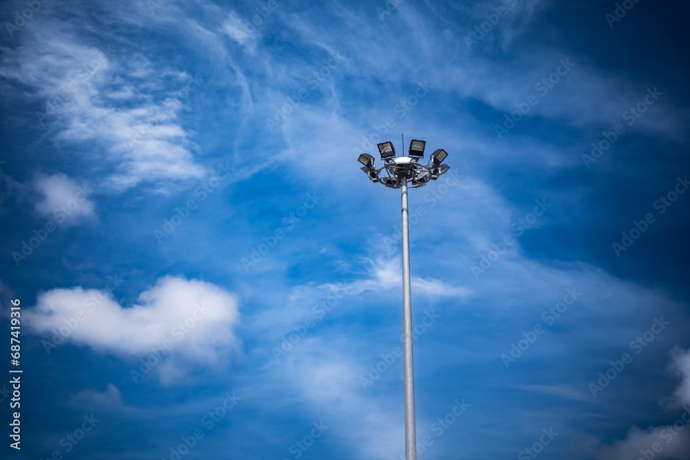 Electrical poles, spotlight poles on the background of the blue sky Electrical poles, spotlight poles on the background of the blue sky