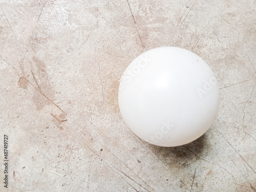 Small white plastic ball on concrete table