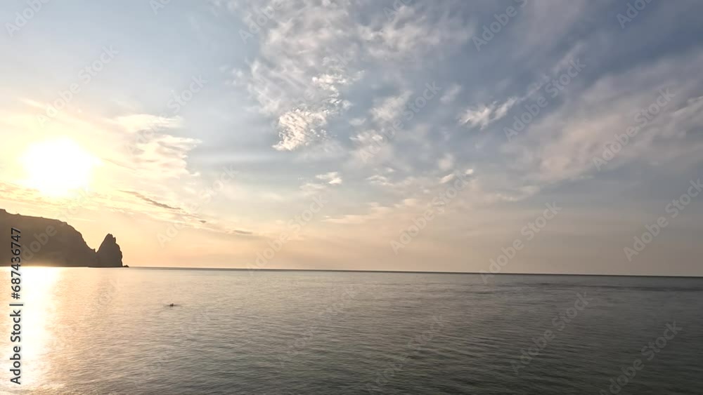 Timelapse fluffy Cumulus clouds moving in bright sunset sky over calm sea. Abstract aerial nature summer ocean sunset, sea and sky view. Vacation, travel, holiday concept. Weather and Climate Change Timelapse fluffy Cumulus clouds moving in bright sunset sky over calm sea. Abstract aerial nature summer ocean sunset, sea and sky view. Vacation, travel, holiday concept. Weather and Climate Change