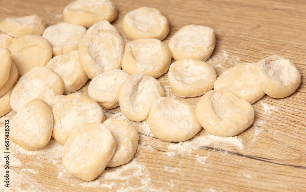 Dough for dumplings on a wooden table Dough for dumplings on a wooden table