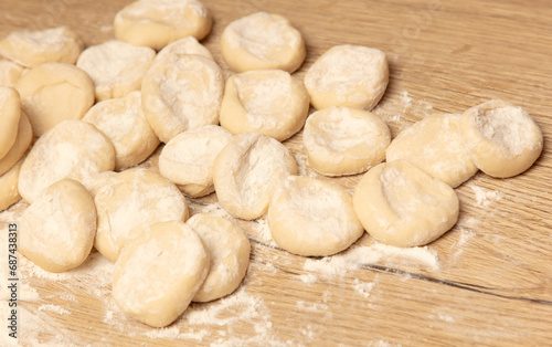 Dough for dumplings on a wooden table