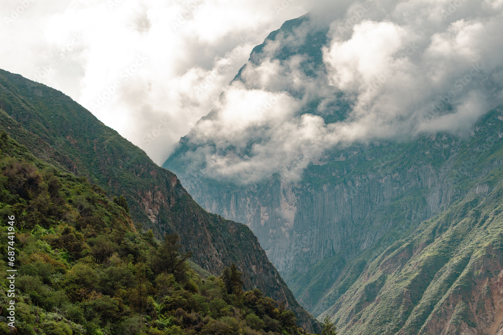 Spectacular and amazing beautiful panorama of the Andes Mountains in the Colca Canyon, Peru. White clouds, wonderful cloudscape. Cliff, blue sky.