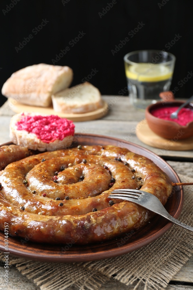 Tasty homemade sausages served on wooden table Tasty homemade sausages served on wooden table