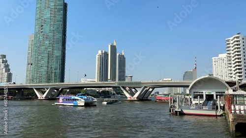 Bangkok, Thailand - January 28, 2023: View of King Taksin the Great Bridge and a passing boat photo
