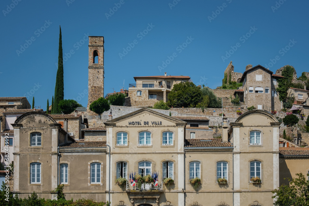 View from the main square on the town hall and houses of the small village of Charme Sur Rhone in the south of France (Ardeche)