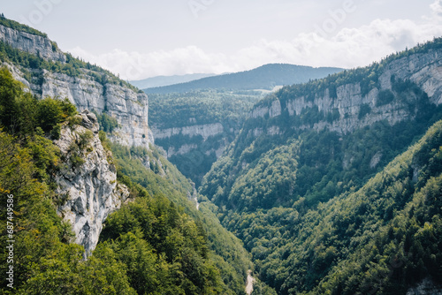 View on the Alps and the mountains of Vercors mountain range from the hiking trail of the Bourne river canyon in the French Alps (Isere) photo