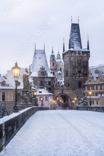 Charles Bridge in Prague with snow during Christmas time in the morning. Snowy Prague.
